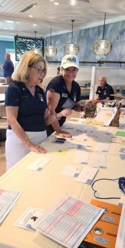Laura-Geberth-and-Director-Bernadette-DiPino-organzing-prizes-for-the-golfers